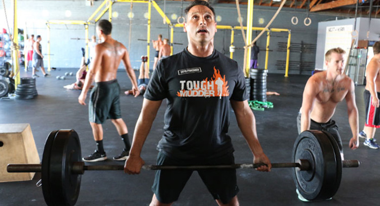 healthy man performs deadlift in the gym at our drug rehab