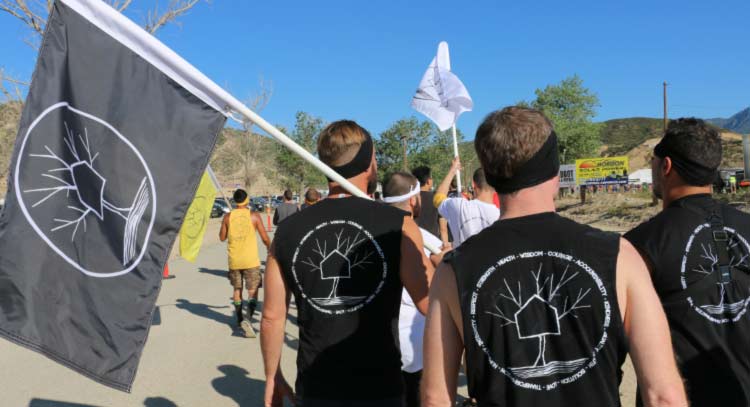 men in recovery at sober event carrying flags