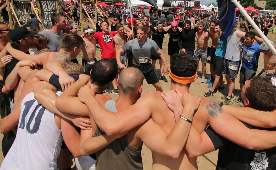 drug rehab clients huddle before warrior dash