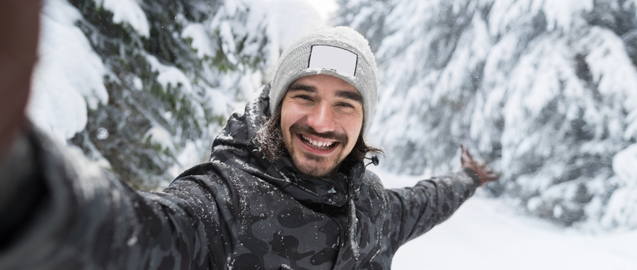 man smiling in snow enviroment
