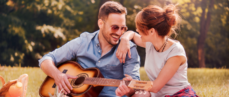 women and man enjoying guitar playing