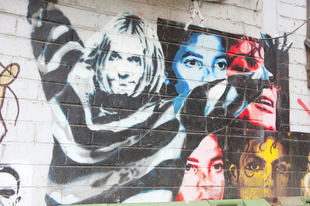 Image of Kurt Cobain mural on a brick wall.