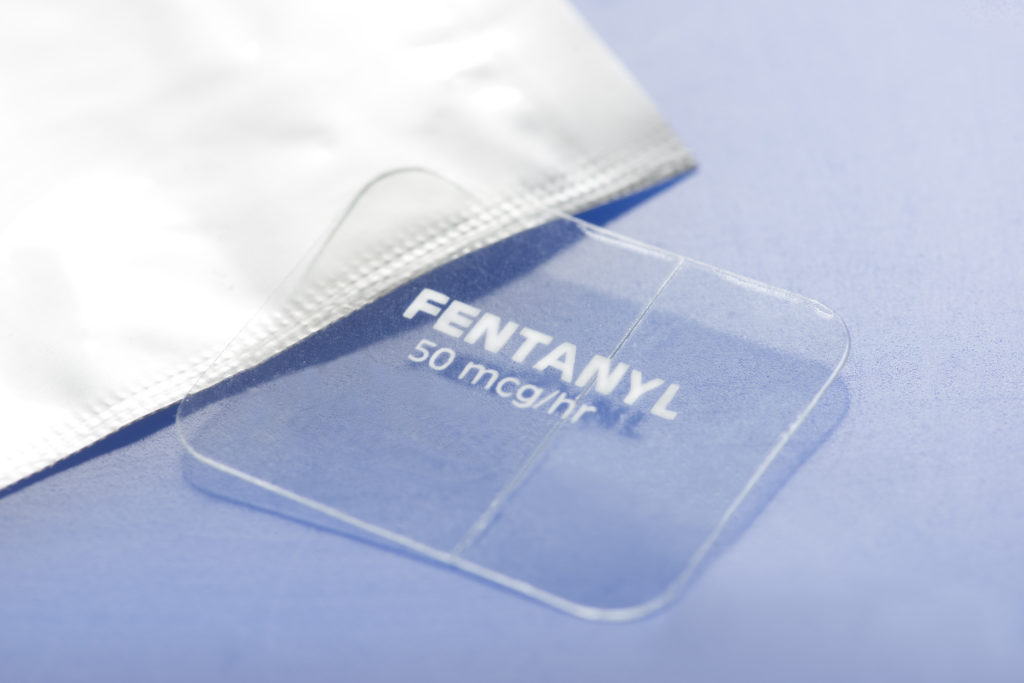 image of Fentanyl transdermal patch. 50mcg/hr timed release skin patch and foil wrapper.